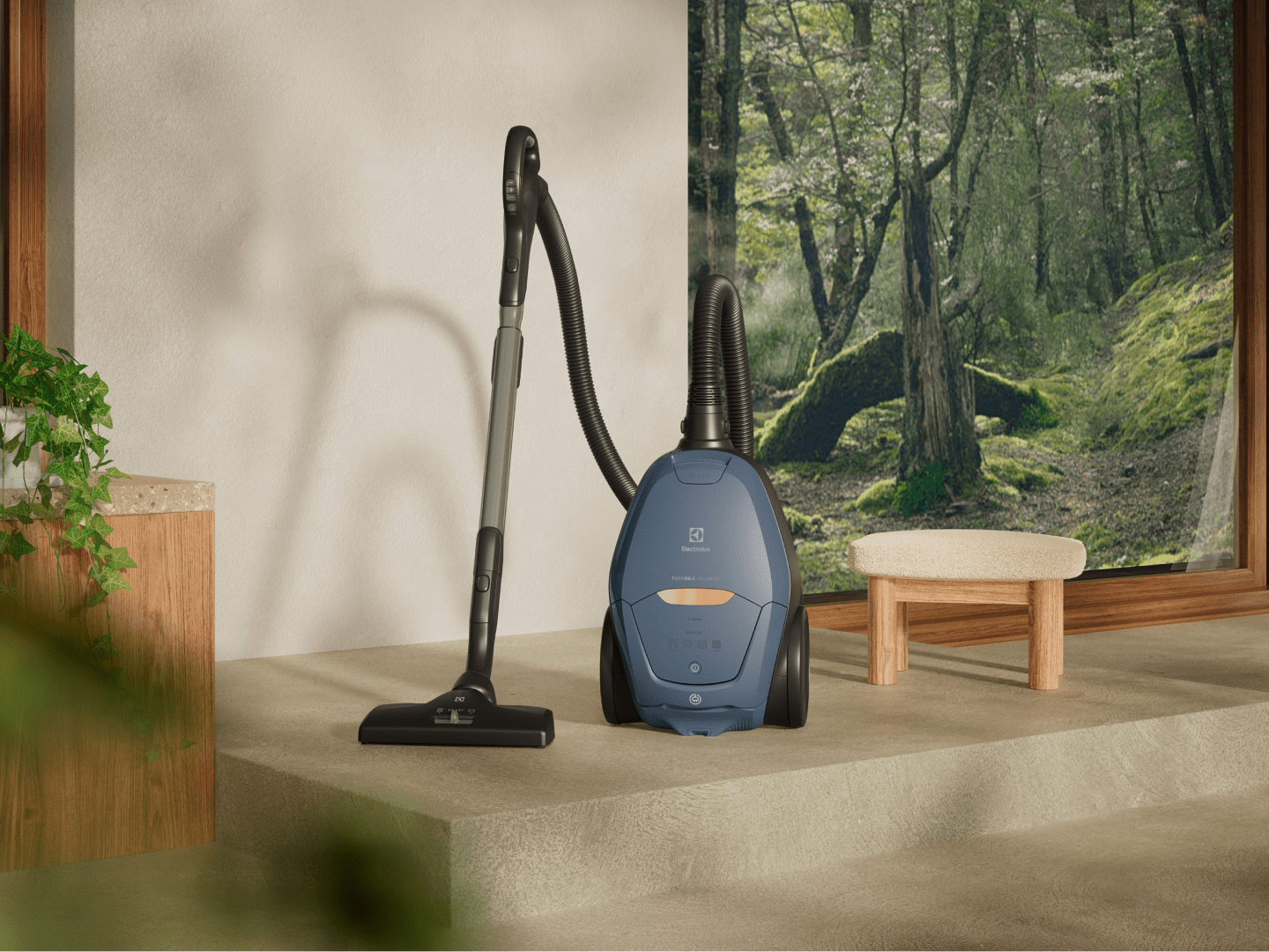 Corded vacuum cleaner in front of a painting